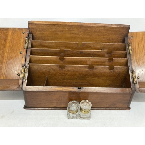 31 - A VINTAGE MAHOGANY TWIN DOOR DESK LETTER BOX WITH TWO GLASS INKWELLS, WITH KEY