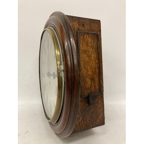 45 - A VINTAGE OAK CASED RAILWAY CLOCK WITH PENDULUM AND KEY