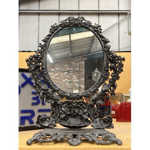 57 - A VICTORIAN STYLE CAST DRESSING TABLE MIRROR WITH ORNATE FLORAL DESIGN