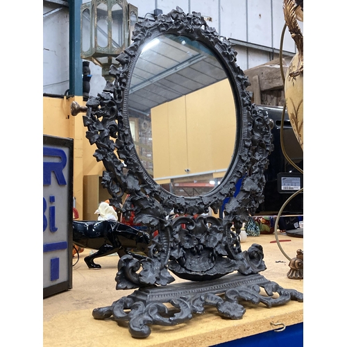 57 - A VICTORIAN STYLE CAST DRESSING TABLE MIRROR WITH ORNATE FLORAL DESIGN