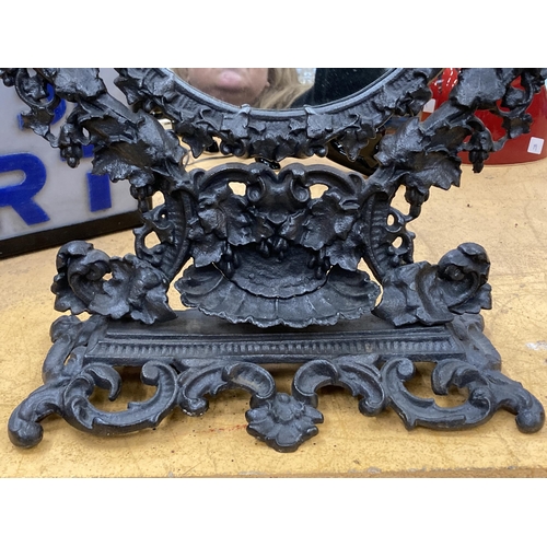 57 - A VICTORIAN STYLE CAST DRESSING TABLE MIRROR WITH ORNATE FLORAL DESIGN