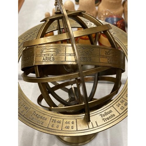 220 - A BRASS REVOLVING GLOBE STYLE DESK COMPASS WITH BIRTH SIGNS