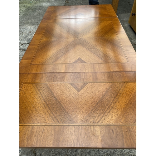 3078 - A MODERN SELVA MAHOGANY AND INLAID COFFEE TABLE WITH FOLD-OVER LEAVES ON X-FRAME BASE