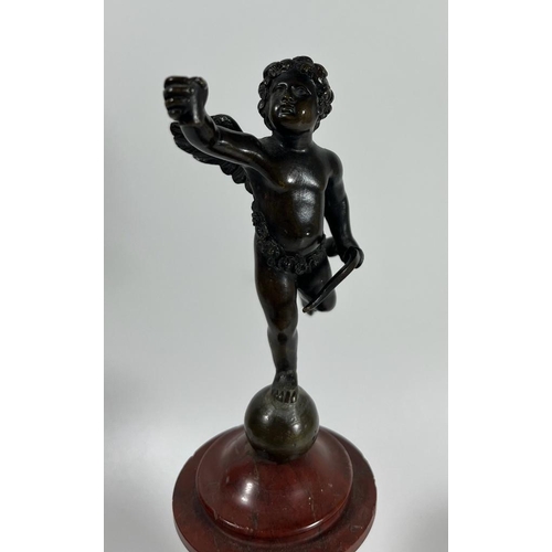 52 - A FRENCH BRONZE MODEL OF CUPID ON A RED MARBLE BASE, HEIGHT 23 CM