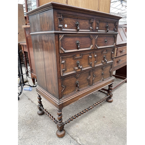 AN EARLY 20TH CENTURY OAK JACOBEAN STYLE CHEST OF TWO SHORT AND THREE ...