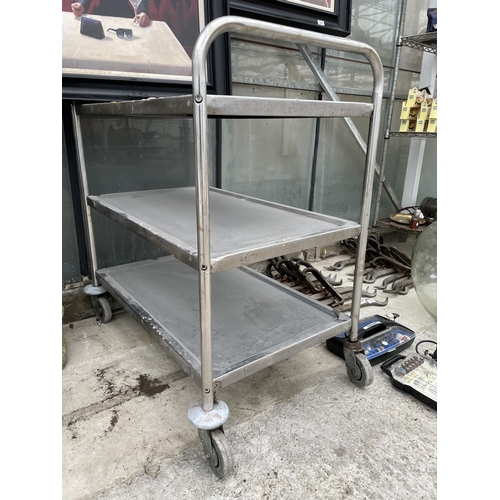 1637 - A THREE TIER STAINLESS STEEL FOUR WHEELED TROLLEY