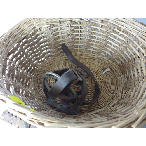 377 - A BASKET CONTAINING A LEATHER SAM BROWNE, SWORD HOLDER, STIRRUPS ETC