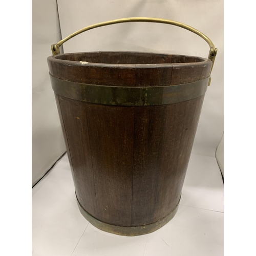 20A - A TALL VINTAGE WOODEN BUCKET WITH BRASS HANDLE AND BANDING