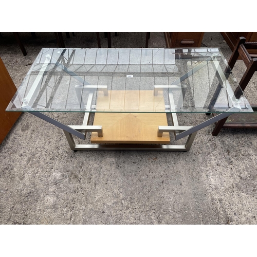 3065 - A RETRO GLASS TOPPED COFFEE TABLE ON POLISHED STOOL MAINFRAME WITH UNDERSHELF, 48 X 24