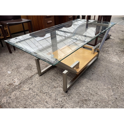 3065 - A RETRO GLASS TOPPED COFFEE TABLE ON POLISHED STOOL MAINFRAME WITH UNDERSHELF, 48 X 24