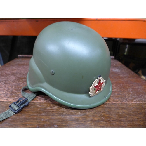 393 - A RUSSIAN TANK HELMET WITH LINER AND BADGE