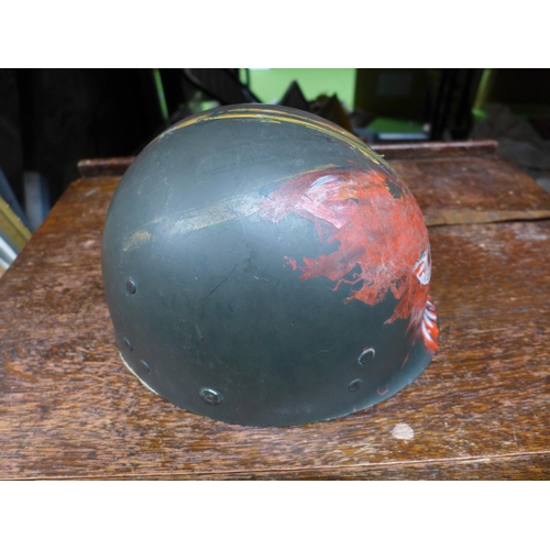 399 - AN UNUSUAL LATE 20TH CENTURY U.S ARMY HELMET LINER WITH HAND PAINTED DECORATION OF A DEVIL FACE WITH... 