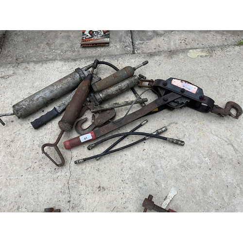 91 - AN ASSORTMENT OF ITEMS TO INCLUDE GREASE GUNS AND A WINCH ETC NO VAT