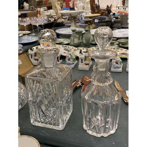 180 - A GROUP OF FOUR CUT GLASS DECANTERS