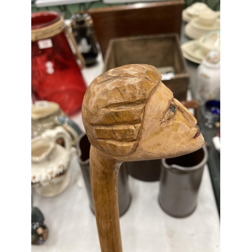 234 - A CARVED WOODEN HEAD WALKING STICK