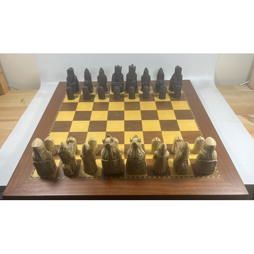 50 - A VINTAGE LEWIS CHESSMEN CHESS SET MODELLED AS MEDIEVAL FIGURES ON AN INLAID WOODEN BOARD, KING HEIG... 