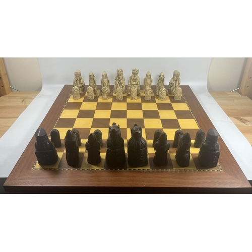 50 - A VINTAGE LEWIS CHESSMEN CHESS SET MODELLED AS MEDIEVAL FIGURES ON AN INLAID WOODEN BOARD, KING HEIG... 