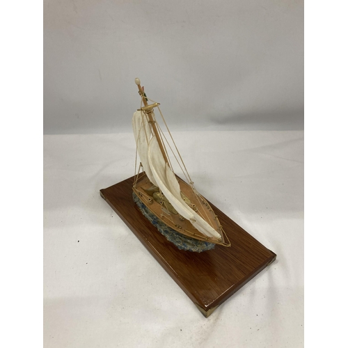 128 - A MODEL OF A VINTAGE ITALIAN YACHT, ON A WOODEN PLINTH, WITH ENAMEL AND BRASS HULL, HEIGHT APPROX 18... 