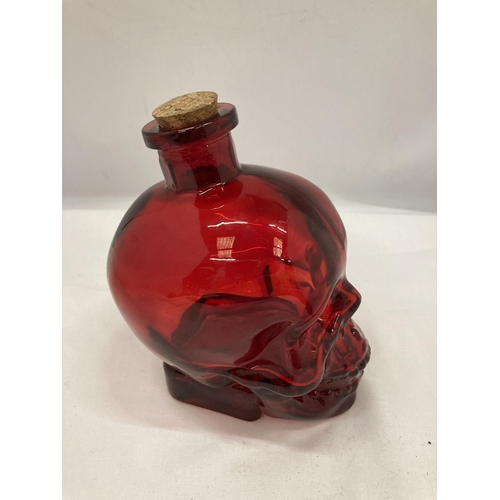 145 - A RED DOUBLE THICKNESS GLASS DECANTER, HEIGHT 16CM