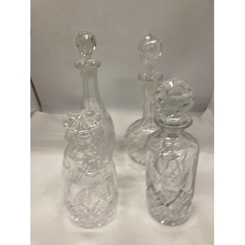 149 - FOUR CUT GLASS DECANTERS OF VARYING SHAPES