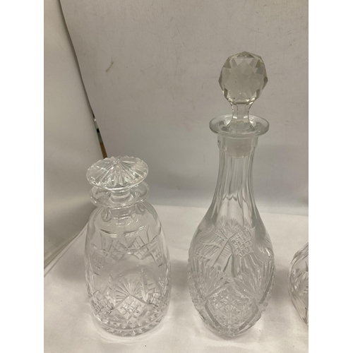 149 - FOUR CUT GLASS DECANTERS OF VARYING SHAPES