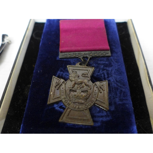 403 - A CASED REPLICA VICTORIA CROSS AND A REPLICA IRON CROSS