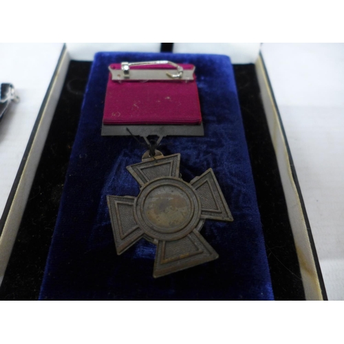 403 - A CASED REPLICA VICTORIA CROSS AND A REPLICA IRON CROSS