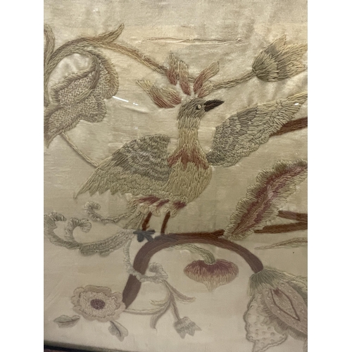 47 - A WALNUT FRAMED VINTAGE SILK EMBROIDERY OF A BIRD AMONGST FLOWERS