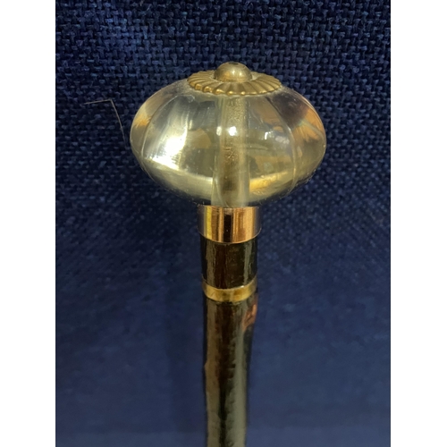 84 - A VINTAGE WALKING STICK WITH GLASS TOP AND METAL BANDING