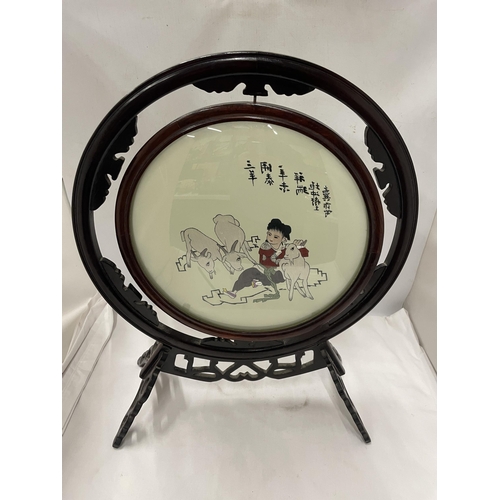 89 - A CHINESE WOODEN FRAMED CIRCULAR PRINT OF A GIRL WITH GOATS