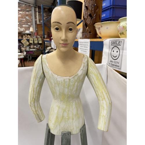 94 - AN UNUSUAL PAINTED WOODEN DOLL ON STAND WITH MOVEABLE ARMS