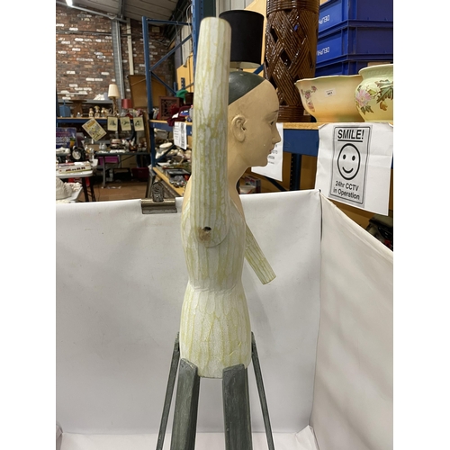 94 - AN UNUSUAL PAINTED WOODEN DOLL ON STAND WITH MOVEABLE ARMS