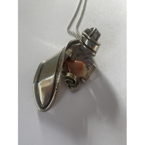 571 - AN ORNATE WHITE METAL SPOON AND AGATE PENDANT