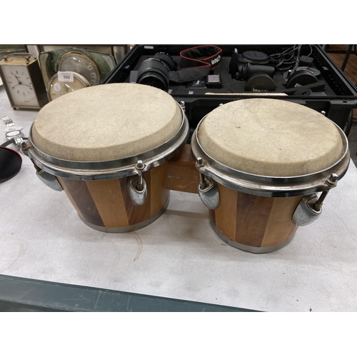 299 - A PAIR OF WOODEN BONGO DRUMS