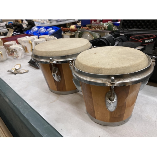 299 - A PAIR OF WOODEN BONGO DRUMS