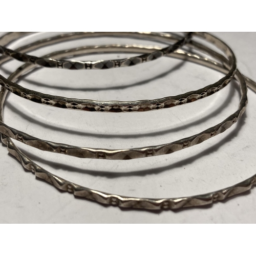 654 - FOUR SILVER BANGLES