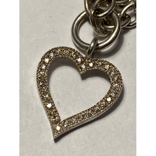 660 - A SILVER T-BAR NECK CHAIN WITH DIAMANTE HEART CHARM