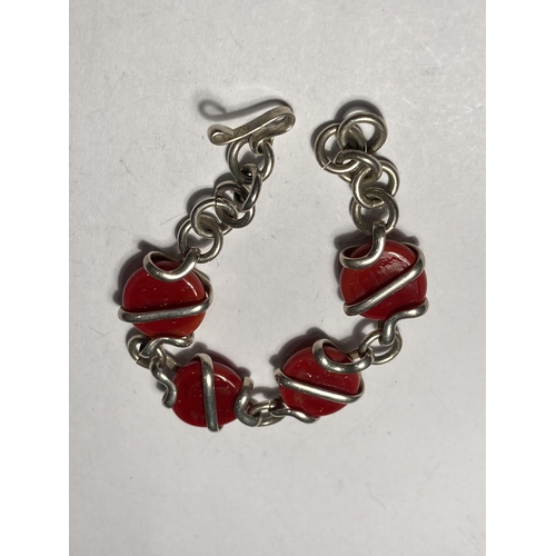 668 - A SILVER AND RED STONE BRACELET