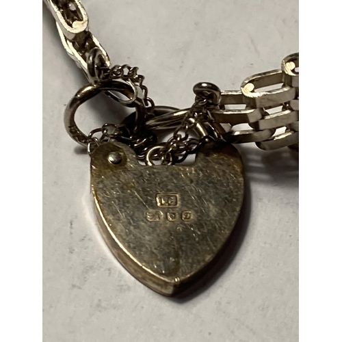 673 - A SILVER FIVE BAR GATE BRACELET WITH HEART PADLOCK