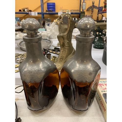 175 - A PAIR OF DUTCH AMBER COLOURED THREE SIDED DECANTERS WITH PEWTER BASE AND TOP, HEIGHT 25CM