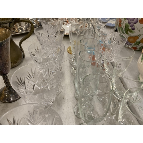 233 - A LARGE QUANTITY OF GLASSES TO INCLUDE A PAIR OF BOXED TUTBURY CRYSTAL BRANDY GLASSES, WINE, CHAMPAG... 