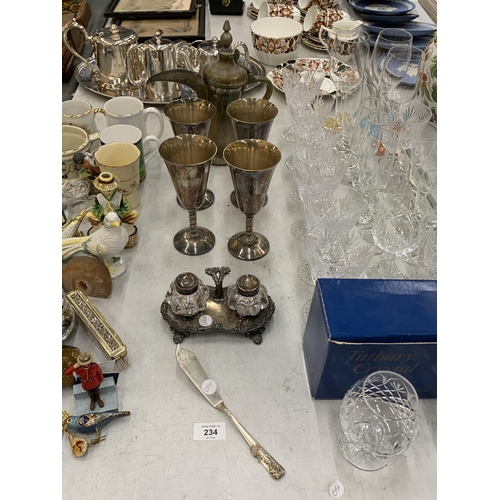 234 - FOUR LARGE PLATED WINE GOBLETS, A GLASS CRUET SET ON PLATED BASE, FISH KNIFE AND A TURKISH STYLE BRA... 