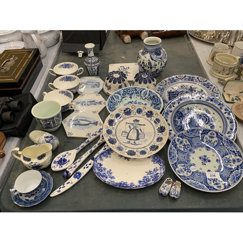 236 - A LARGE QUANTITY OF BLUE AND WHITE CERAMICS TO INCLUDE FISH TILES, SOUP COUPES, JELLY MOULDS, PLATES... 