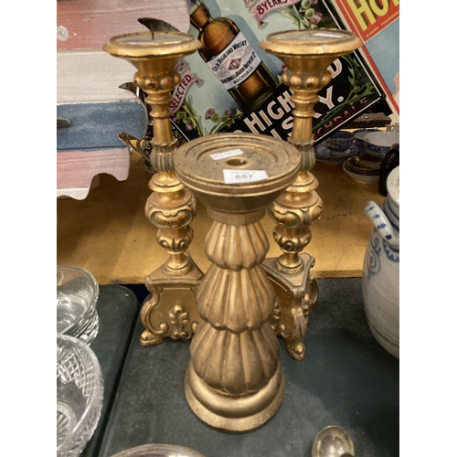 857 - THREE LARGE HEAVY ORNATE GOLD COLOURED CANDLESTICKS, HEIGHT 47CM AND 38CM