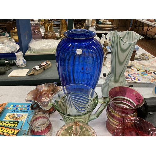 903 - A LARGE QUANTITY OF COLOURED GLASS TO INCLUDE VASES, JUGS, CANDLESTICKS, A BON BON DISH, CARNIVAL GL... 