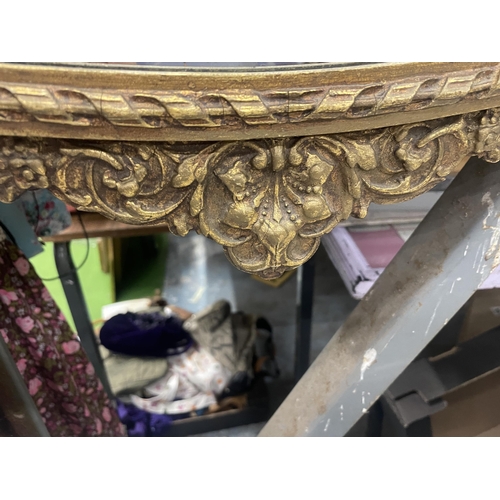 100 - A VINTAGE GILT FRAMED ORNATE MIRROR