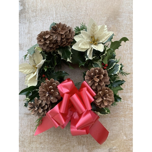 123 - FOUR WREATHS WITH CREAM POINSETTIA, CONES AND RED/BURGUNDY RIBBON + VAT. TO BE SOLD FOR THE FOUR