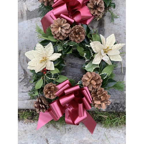 125 - FOUR WREATHS WITH CREAM POINSETTIA, CONES AND RED/BURGUNDY RIBBON + VAT. TO BE SOLD FOR THE FOUR