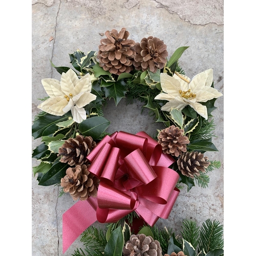 129 - THREE WREATHS WITH CREAM POINSETTIA, CONES AND RED/BURGUNDY RIBBON + VAT. TO BE SOLD FOR THE THREE