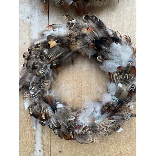 134 - TWO MEDIUM/LARGE FEATHER WREATHS 30CM IN DIAMETER + VAT TO BE SOLD FOR THE PAIR